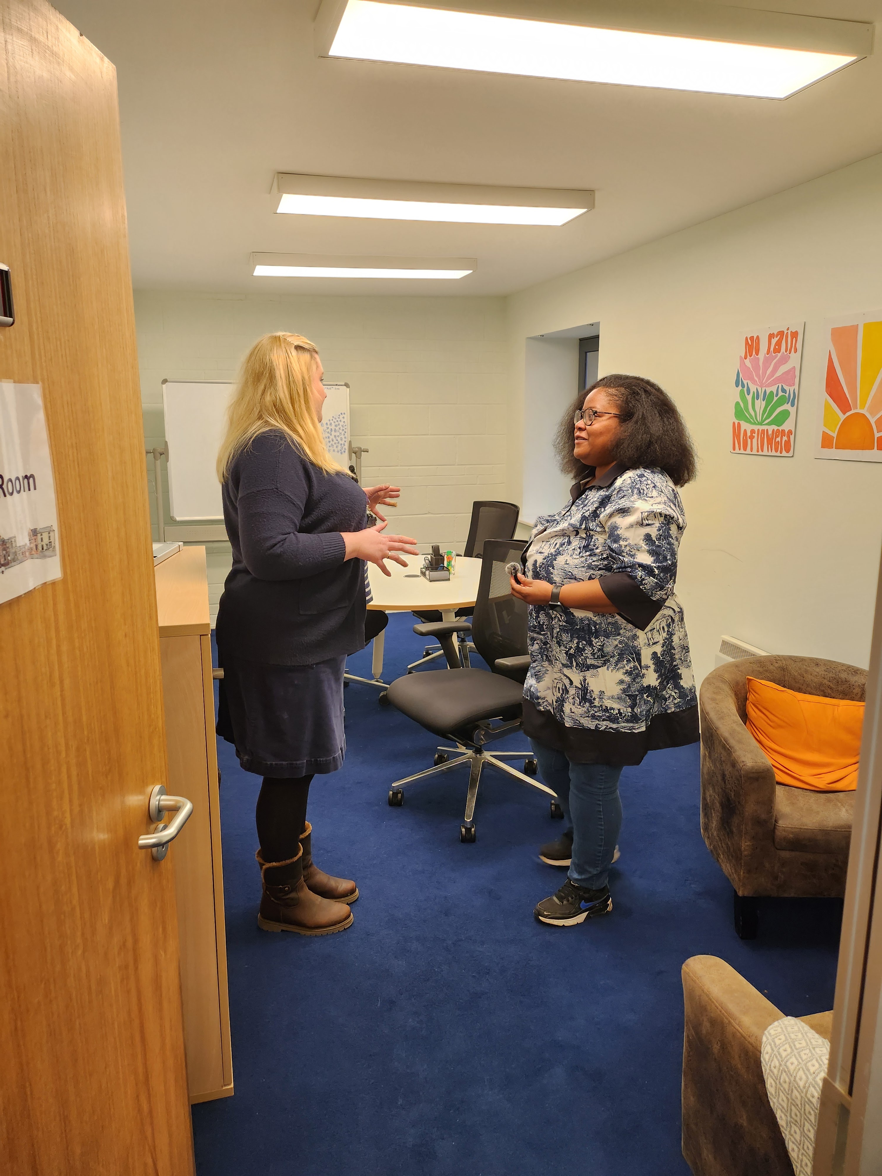 Helen and Natalie in conversation about one of the new meeting rooms. Two women are standing in one of the new meeting/therapy rooms.
