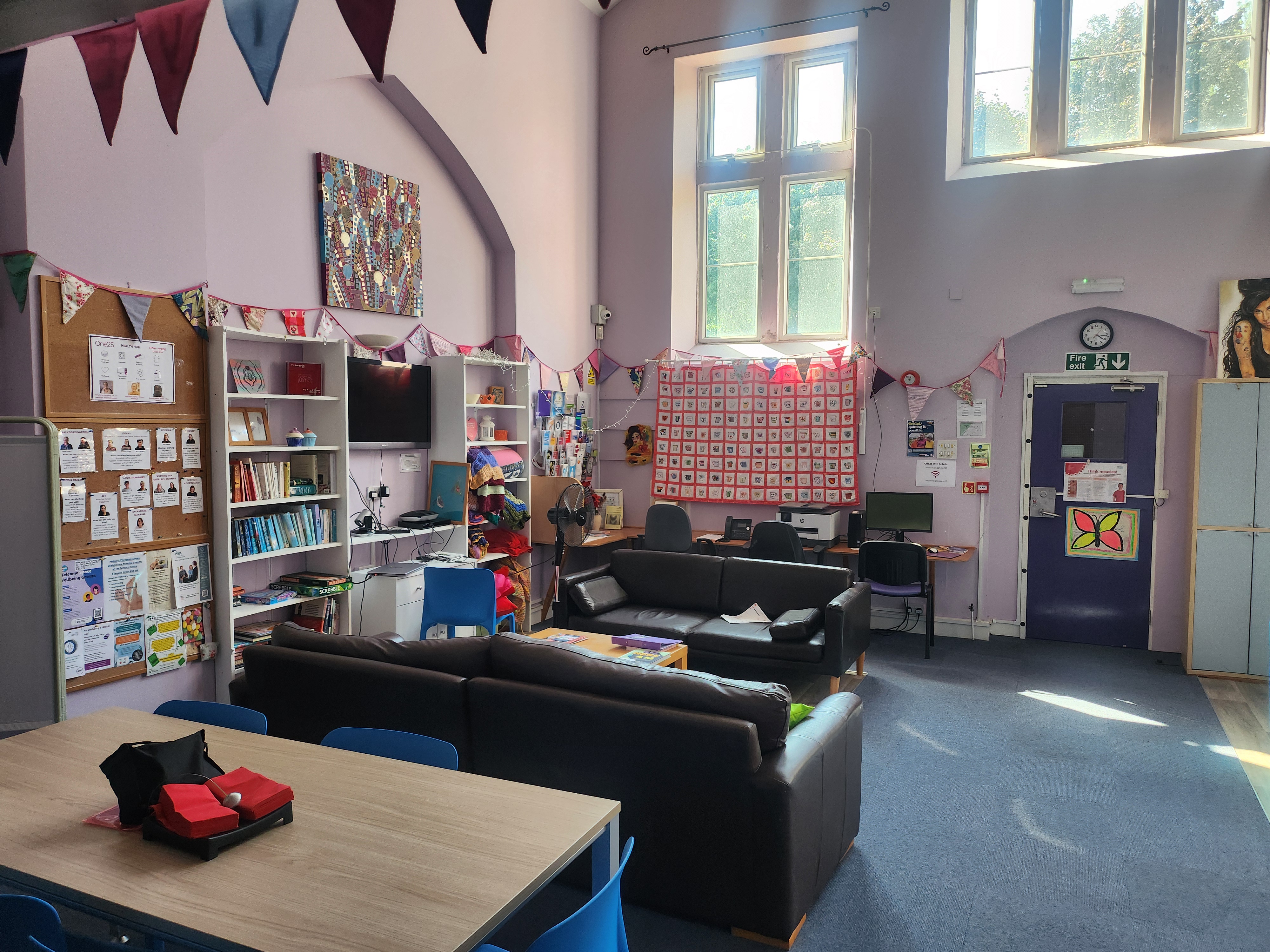 Inside the health hub at One25 seating area with sofas and a table and chairs