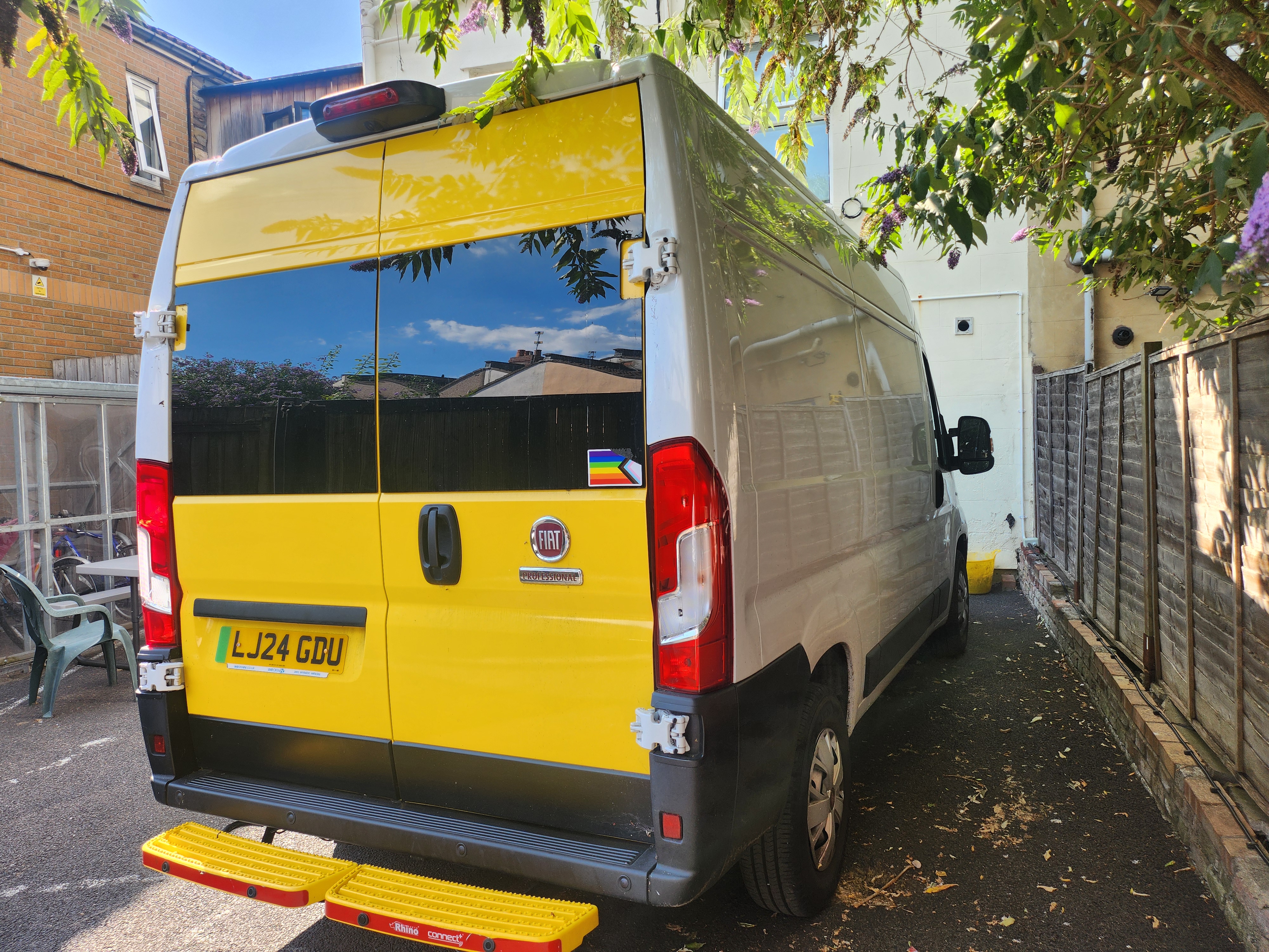The distinctive "custard tart" night outreach van bought with the CRF grant View of a van from the back right side. The back is painted custard yellow and sides are white.