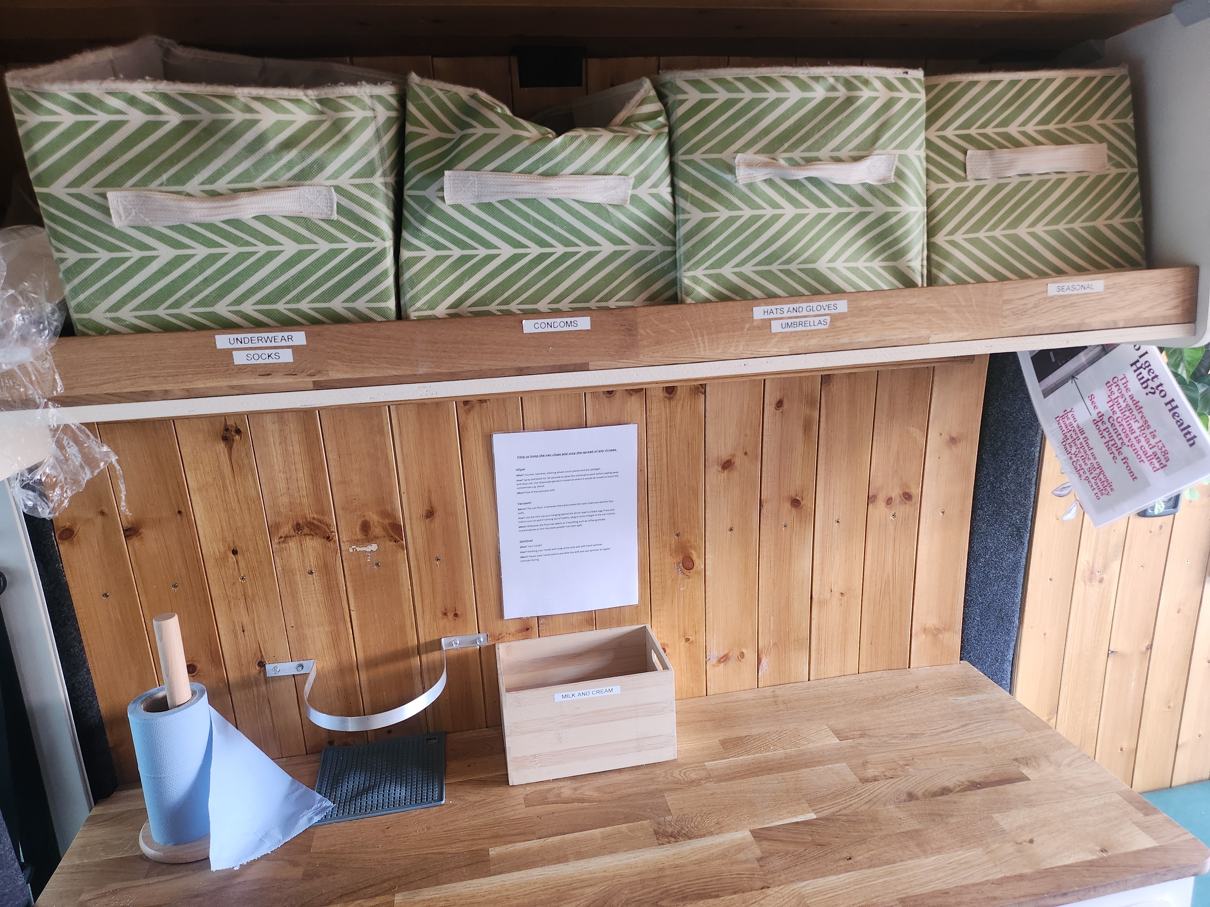 The night outreach van offers a space for a hot drink, food and other essentials for women who street sex work in Bristol Labelled storage cubes and side board inside the outreach van